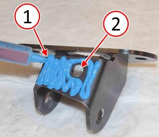 Fig. 9 Apply Adhesive to Shock Bracket Top Surface