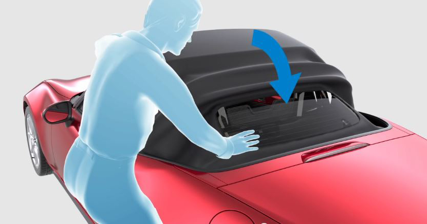Move the top rearward and fold it while pressing the rear glass lightly with your hand