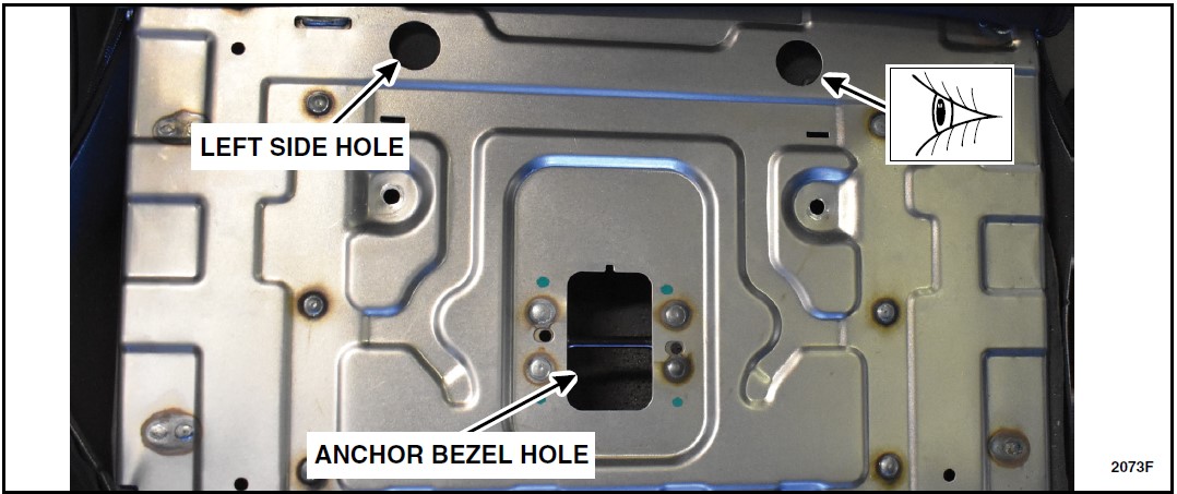 Shine a flashlight inside of the left side hole or the anchor bezel hole while viewing the two welds on the head rest bracket from the right side hole