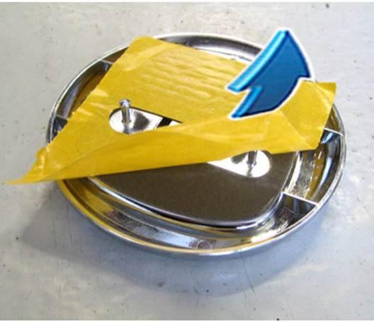 Fig. 6 Remove Adhesive Tape Liner From New Emblem