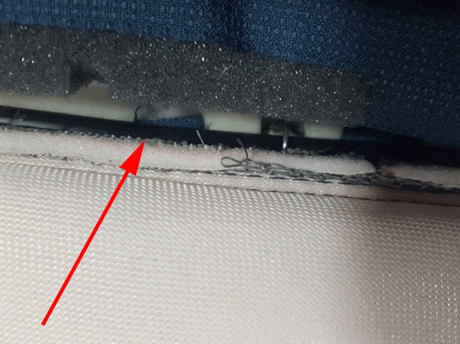 Sensor tail observed trapped between seat trim tiedown feature and cushion pad