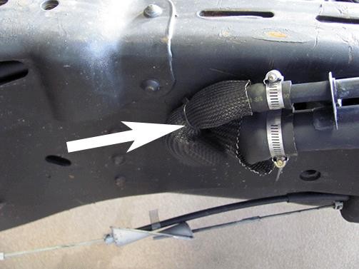 Position the vent hose protective sleeve as shown