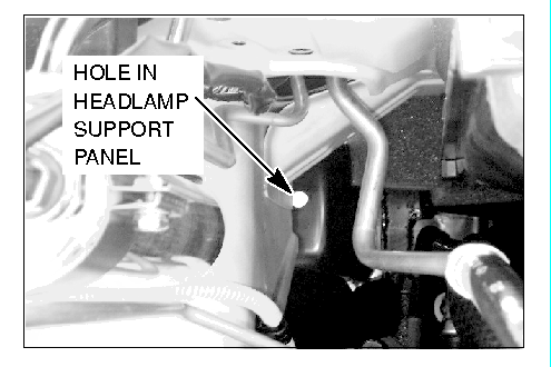 hole in the headlamp support panel
