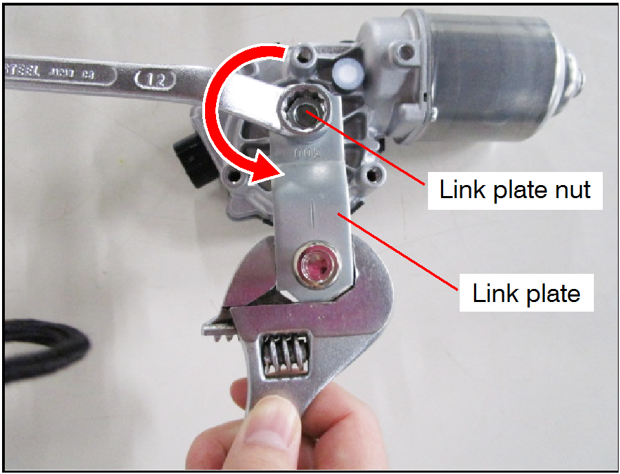 Hold the link plate in place with an adjustable wrench while removing the link plate nut