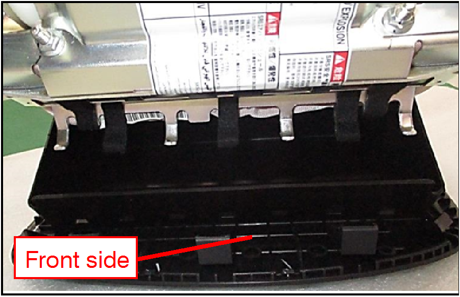 Align the warning label side of the air bag module toward the Front of the air bag module cover