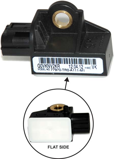 The flat side of a TRW impact sensor is white