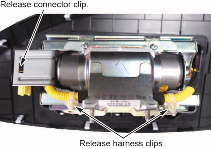 Remove the harness from both ends of the inflator bracket