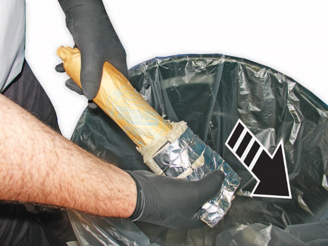 Hold the paper wrapping the inflator with one hand and slide the insulation off into the trash