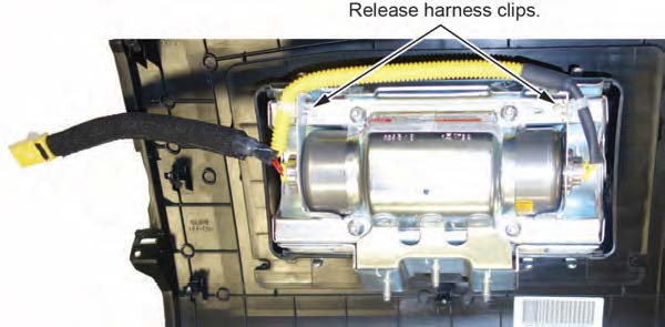 Remove the harness from the inflator bracket