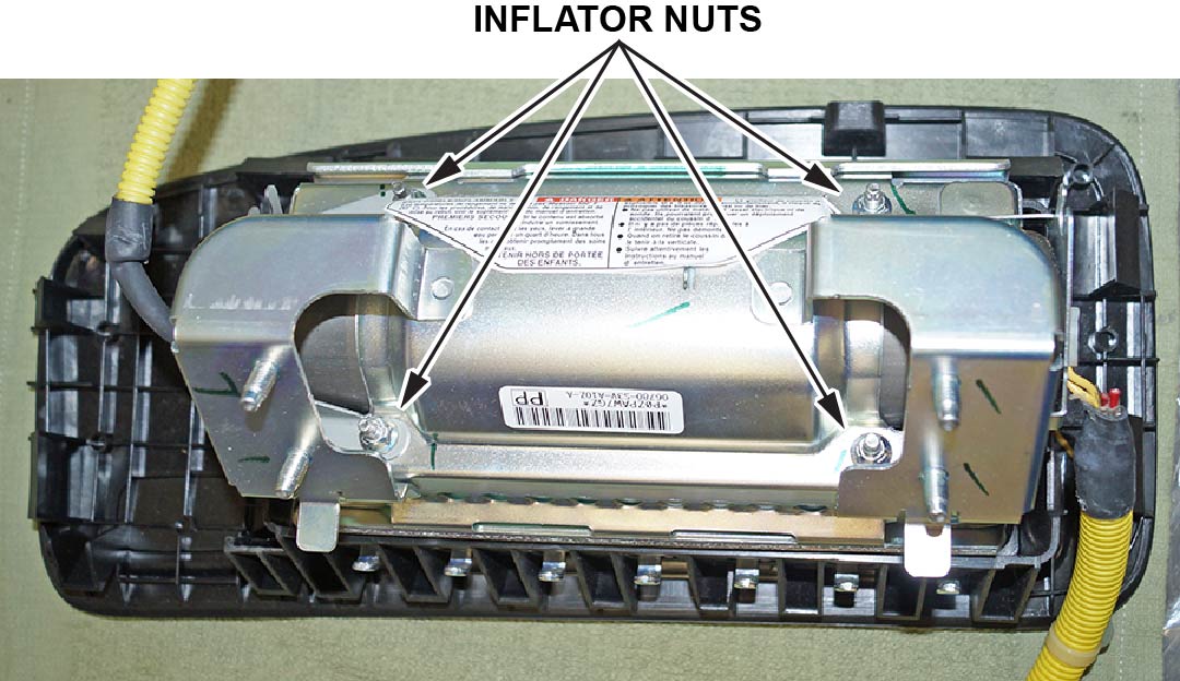 Remove the four inflator nuts