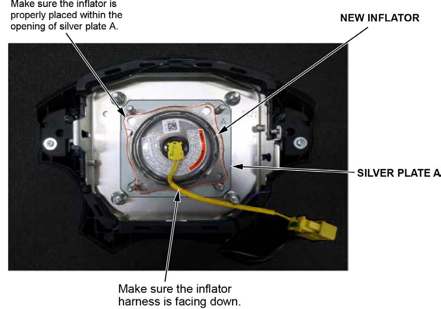 Install the new inflator within the opening of silver plate A with the inflator harness facing downward as shown