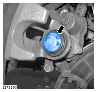 clean the brake caliper piston and apply the supplied grease in the area shown