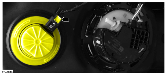 Figure 3 - Chassis cab shown, pickup similar - reductant level sensor/quality module highlighted with arrow pointing to white secondary lock tab