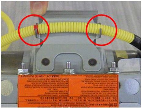 Remove the harness tube from the retainer bracket holders